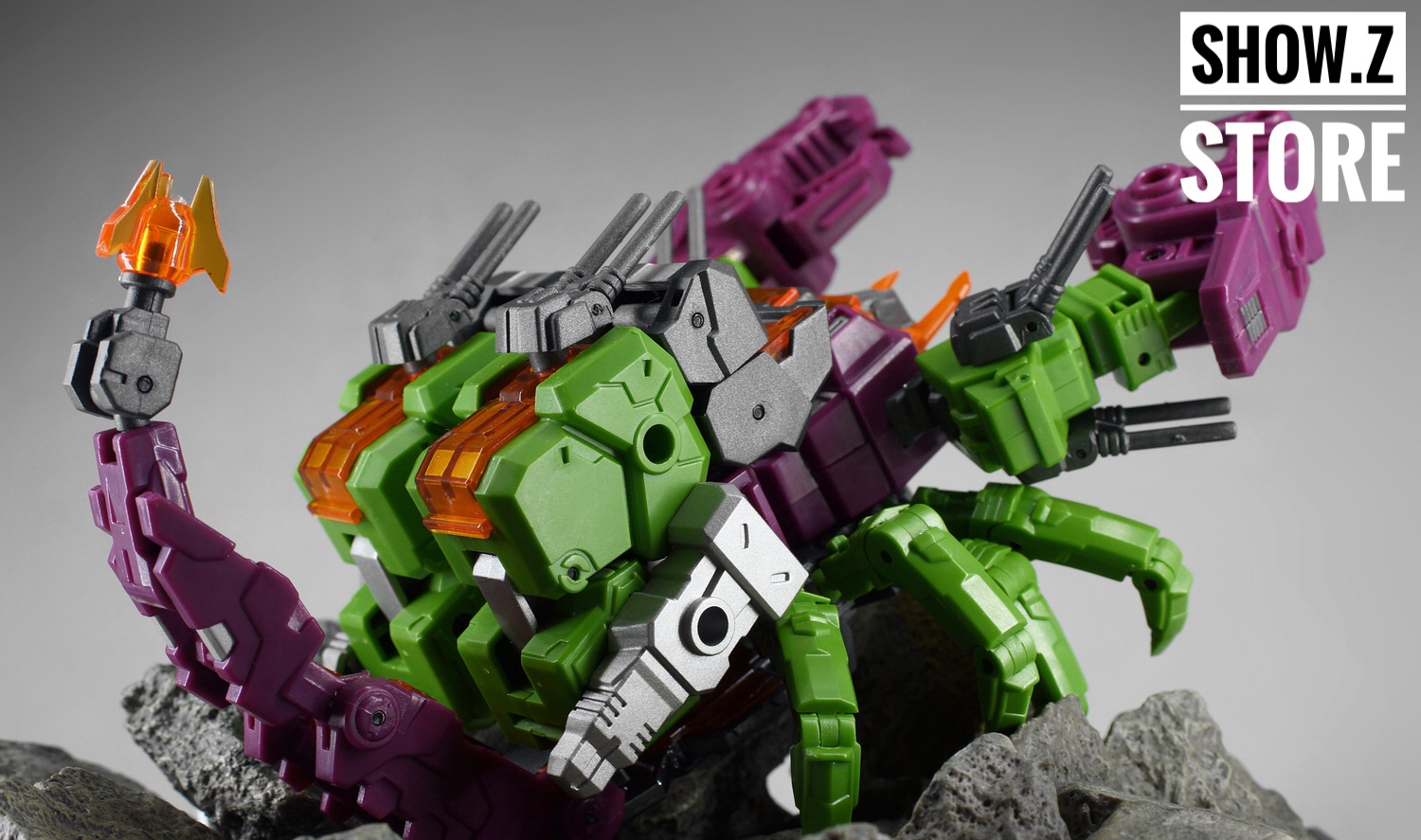 Purple green robot on rocky base with extended arm weapons Purple green robot on rocky base with extended arm weapons