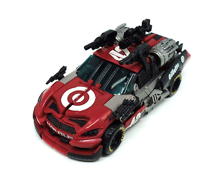 Red race car robot mode with multiple weapon attachments Red race car robot mode with multiple weapon attachments