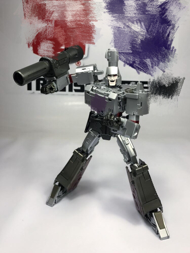 Silver and black robot figure holding cannon weapon in dynamic stance Silver and black robot figure holding cannon weapon in dynamic stance