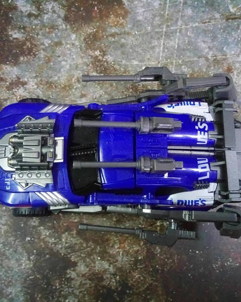 Blue transforming robot in vehicle car mode with black accents Blue transforming robot in vehicle car mode with black accents