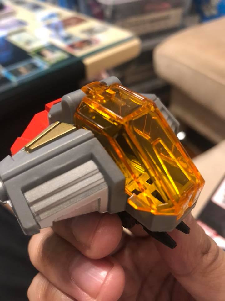 Orange and gray combiner weapon accessory detail Orange and gray combiner weapon accessory detail