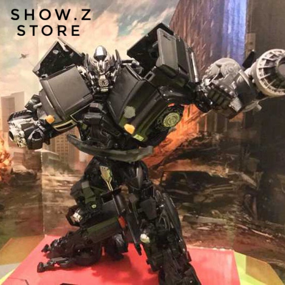 Black Takara Ironhide robot with vehicle mode truck below Black Takara Ironhide robot with vehicle mode truck below
