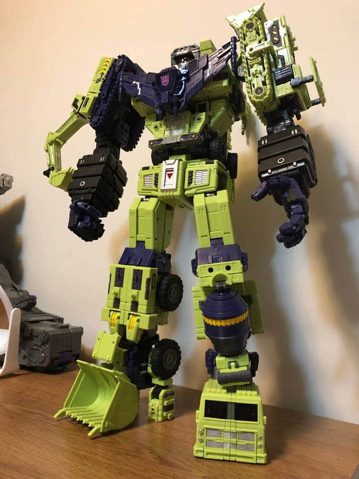 Devastator standing tall with component vehicles separated beside Devastator standing tall with component vehicles separated beside