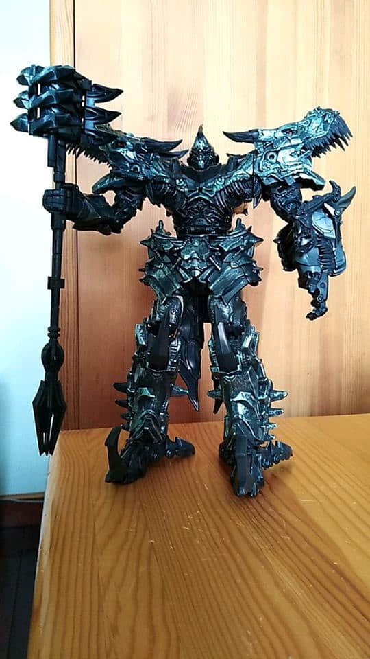 Black metallic robot in full transformation pose Black metallic robot in full transformation pose