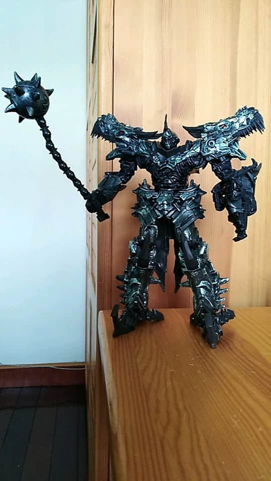 Black spiky armor robot standing with weapon accessory displayed Black spiky armor robot standing with weapon accessory displayed