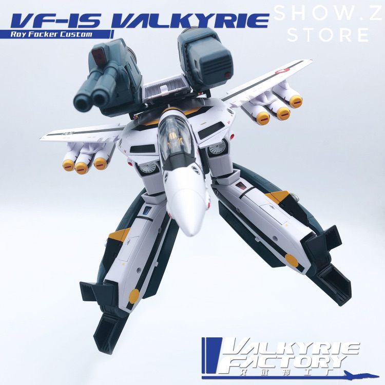 White and blue Valkyrie fighter jet robot with deployed weapon systems shown White and blue Valkyrie fighter jet robot with deployed weapon systems shown