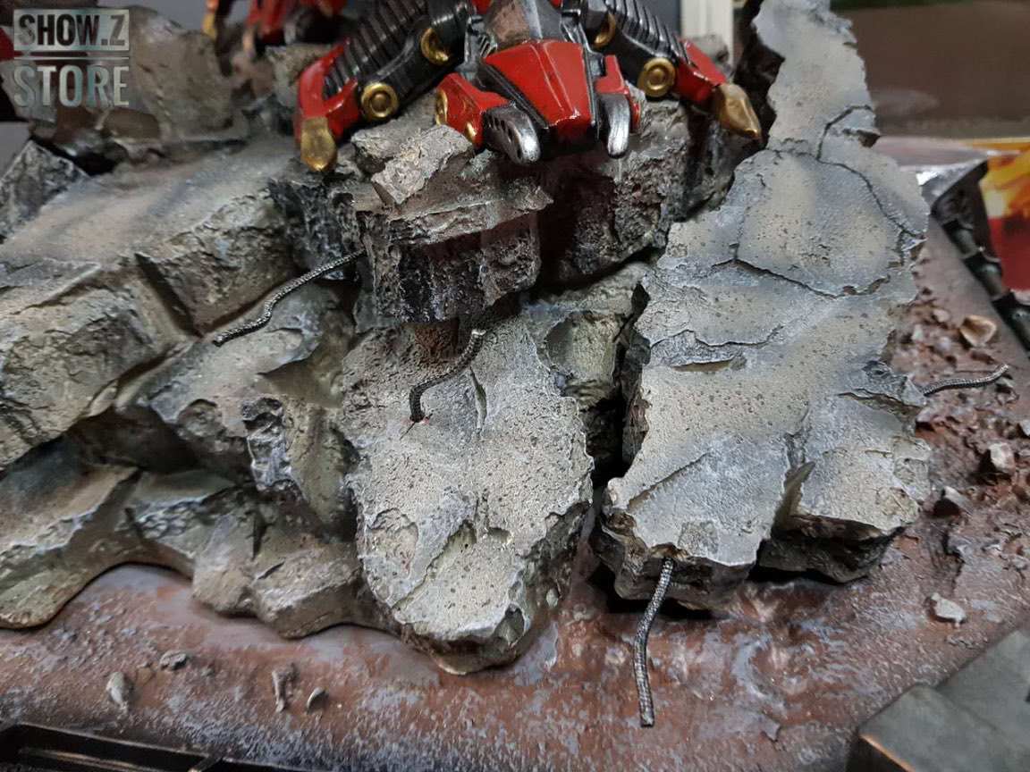 Red robot figure on weathered stone ground base Red robot figure on weathered stone ground base