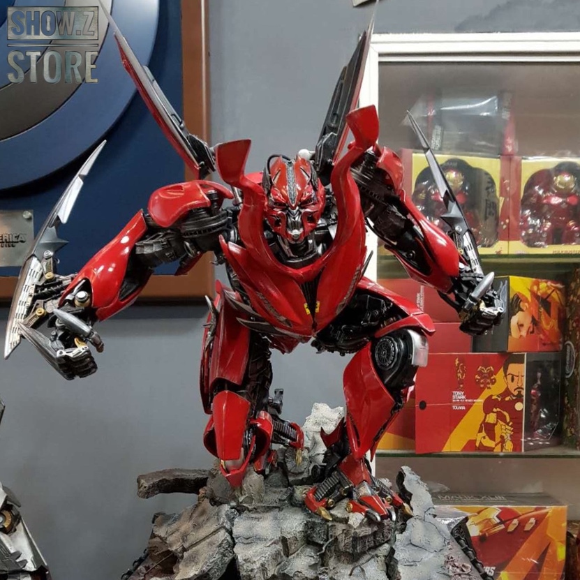 Red robot transformer on rocky terrain base Red robot transformer on rocky terrain base
