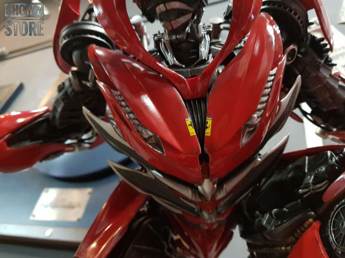 Red and gray robot in aggressive stance display Red and gray robot in aggressive stance display