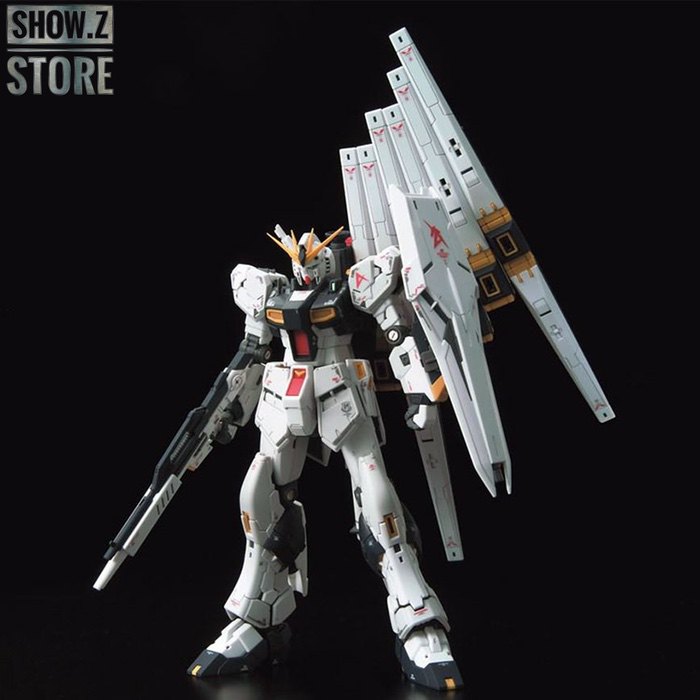 Bandai RG Nu Gundam in white with large frame weapons against dark background Bandai RG Nu Gundam in white with large frame weapons against dark background