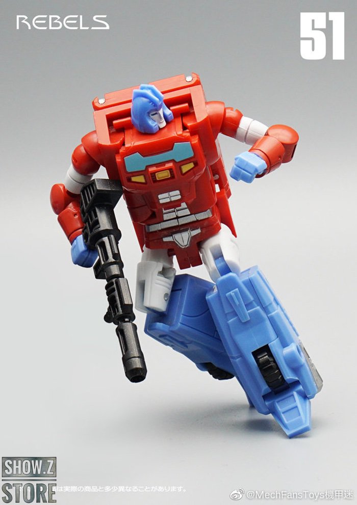 Red blue and gold robot figure showing transformation and weapon systems Red blue and gold robot figure showing transformation and weapon systems