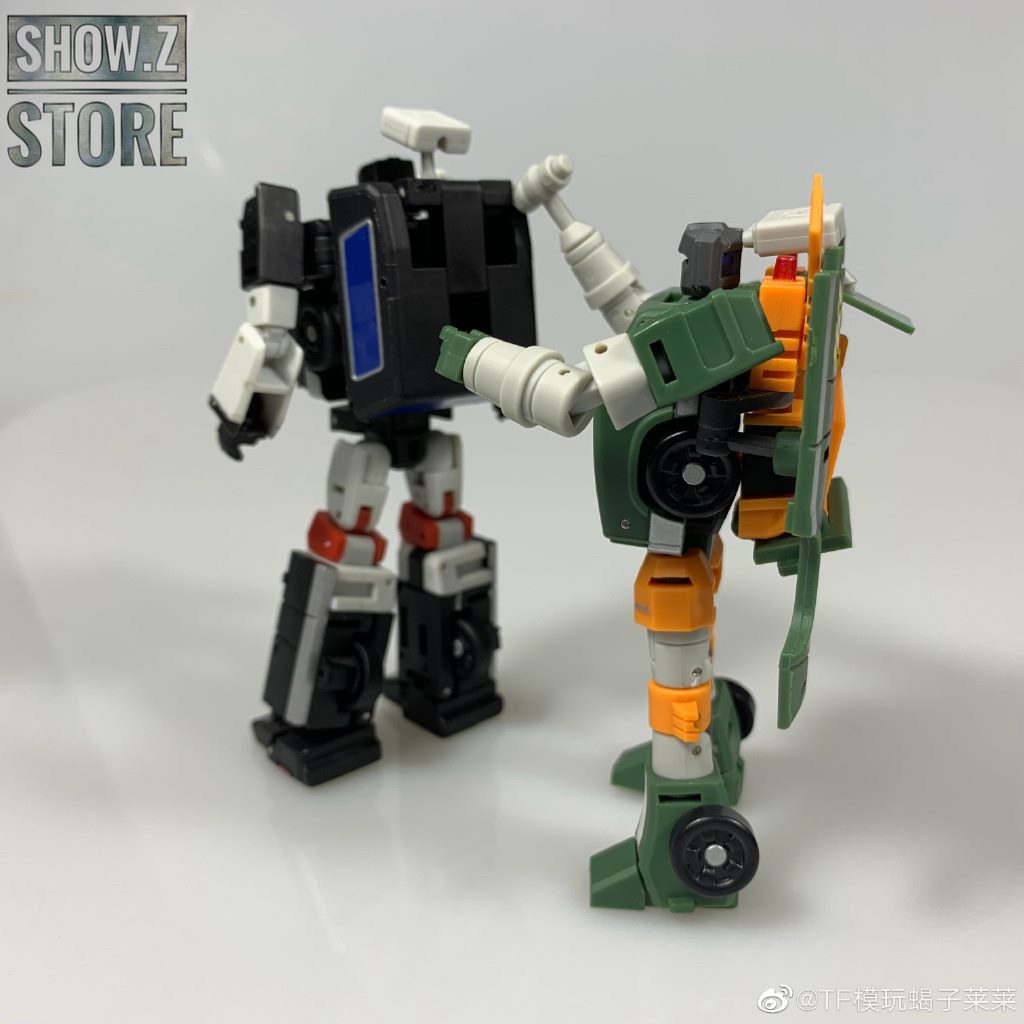 Two robots posed together displaying Crane Hoist transformation scale Two robots posed together displaying Crane Hoist transformation scale