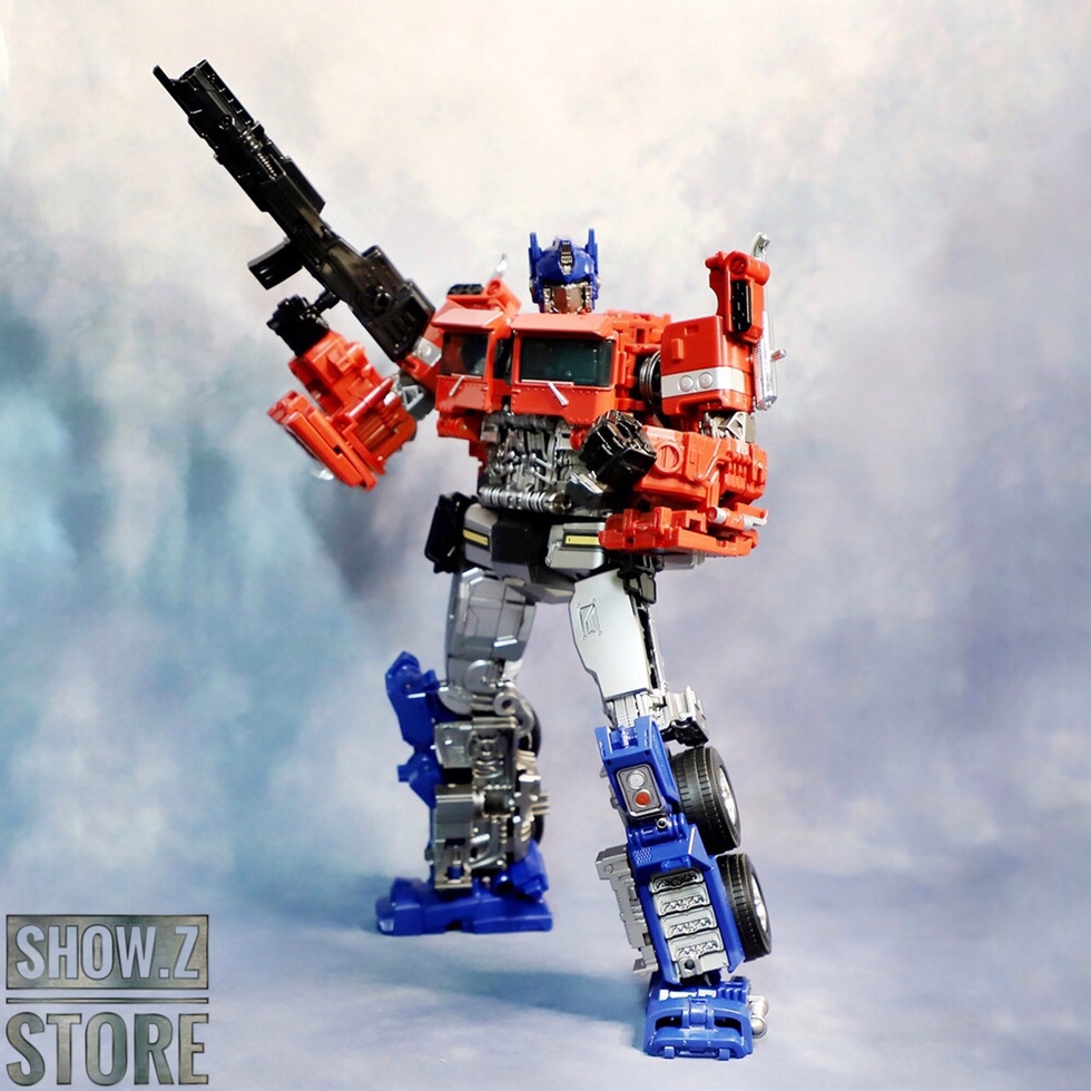 Bright red and blue Optimus Prime robot with large black rifle weapon Bright red and blue Optimus Prime robot with large black rifle weapon