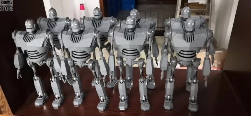 Row of identical white robot figures standing in formation lineup Row of identical white robot figures standing in formation lineup