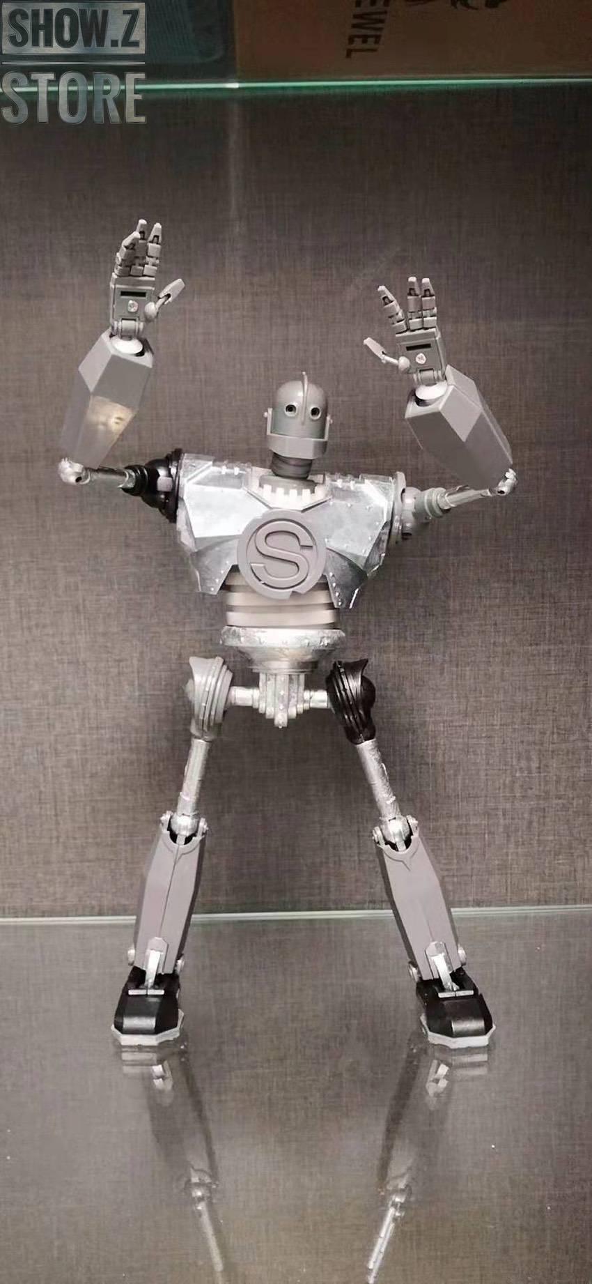 White metal robot displayed in dynamic jumping action pose White metal robot displayed in dynamic jumping action pose