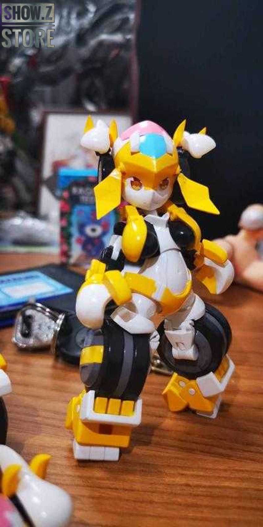 Yellow and white robot figure with black tires in action pose Yellow and white robot figure with black tires in action pose