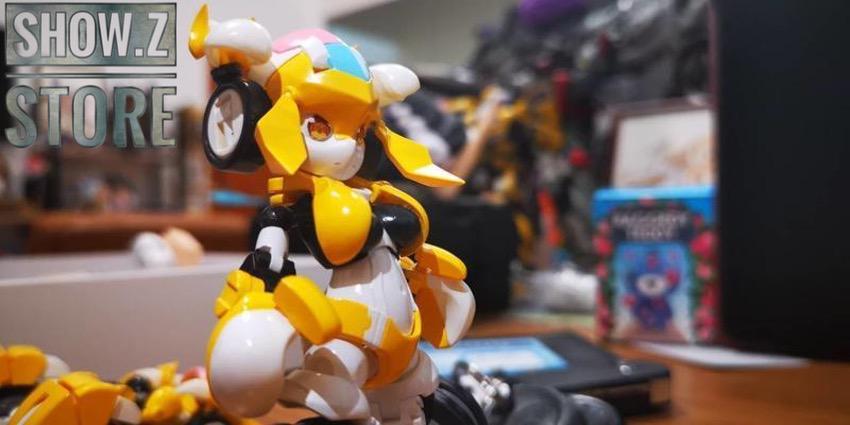 Yellow robot toy with large black wheels and articulated limbs Yellow robot toy with large black wheels and articulated limbs