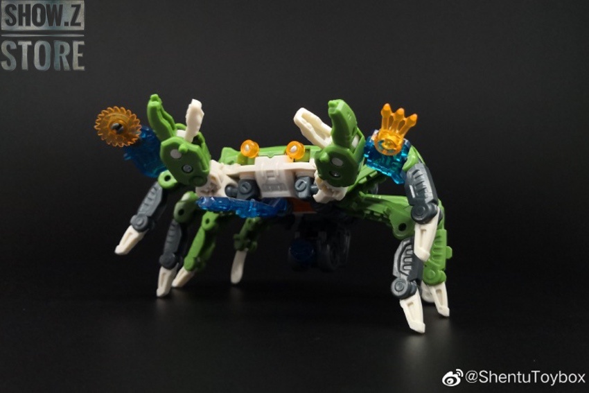Green mechanical beast robot with extended limbs in action pose Green mechanical beast robot with extended limbs in action pose