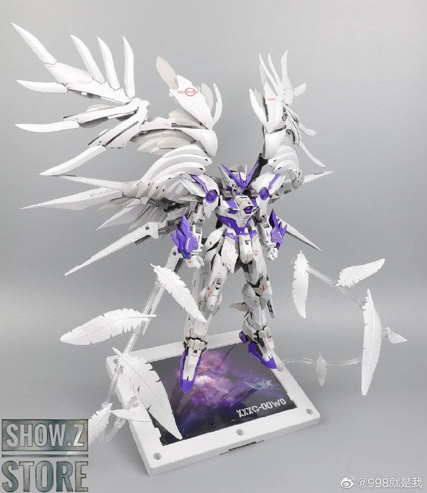 Gundam model with intricate white wing details and purple accents Gundam model with intricate white wing details and purple accents