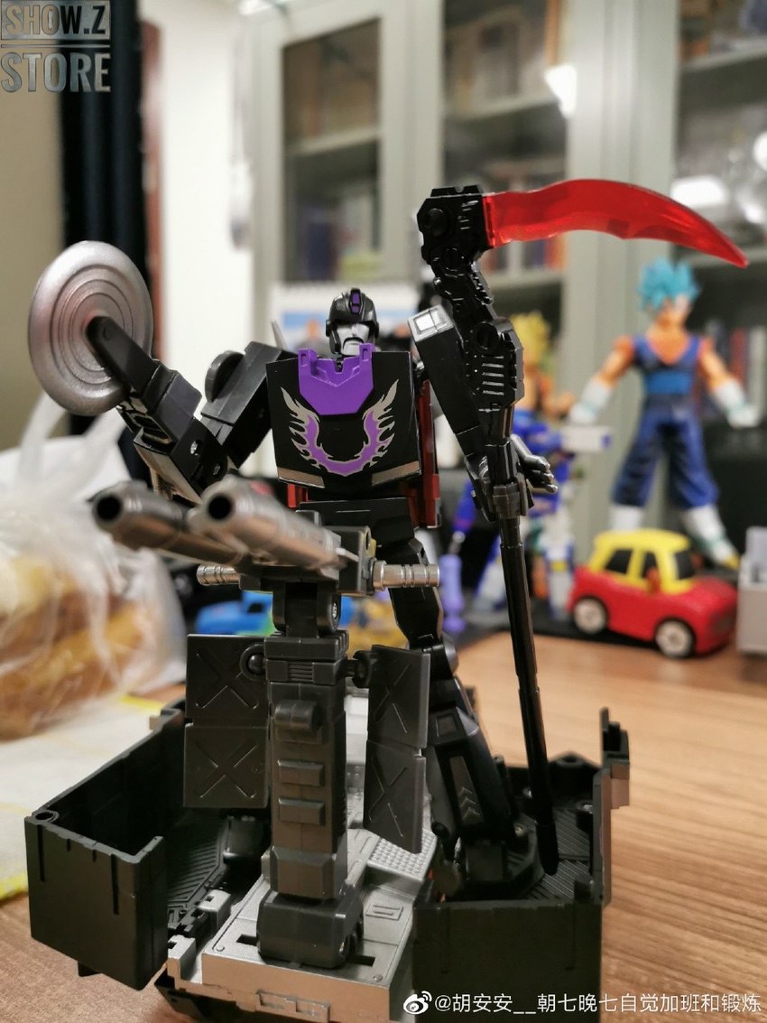 Purple and black robot with articulated weapon attachments Purple and black robot with articulated weapon attachments