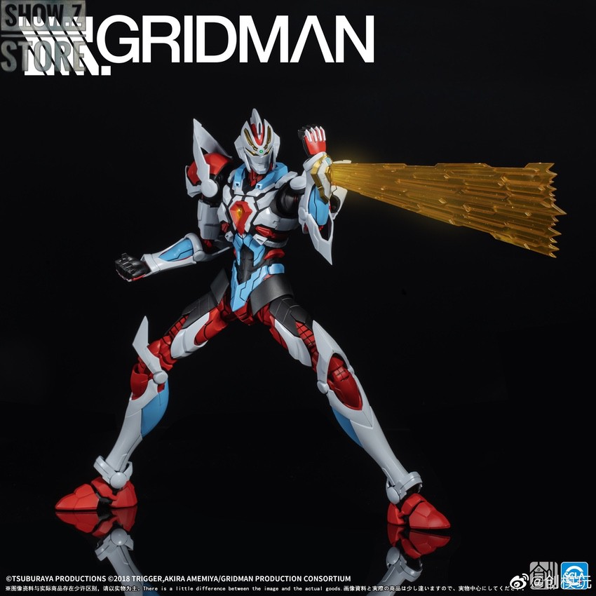 Gridman robot equipped with golden beam sword weapon in action pose Gridman robot equipped with golden beam sword weapon in action pose
