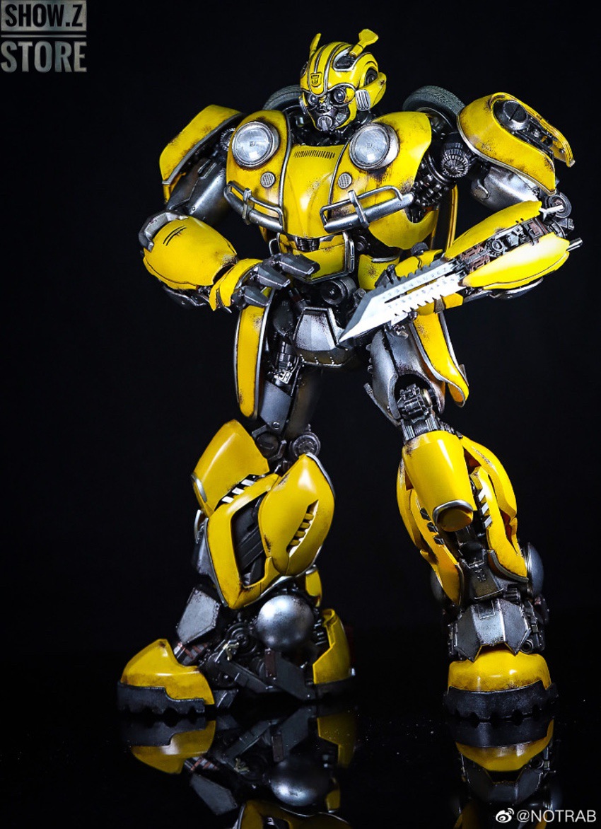 Yellow and black armored robot with extended weaponry displayed Yellow and black armored robot with extended weaponry displayed