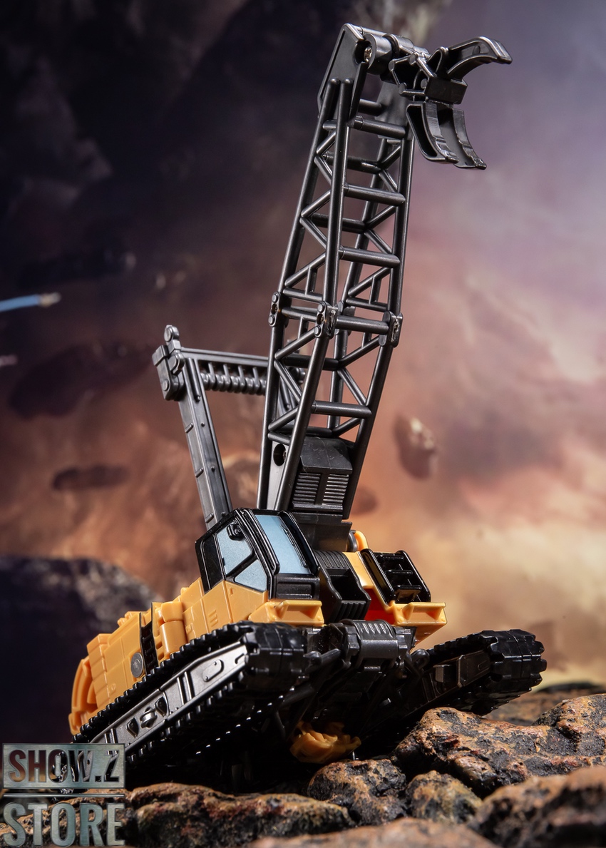 Yellow robot figure with extending boom arm in vehicle transformation Yellow robot figure with extending boom arm in vehicle transformation