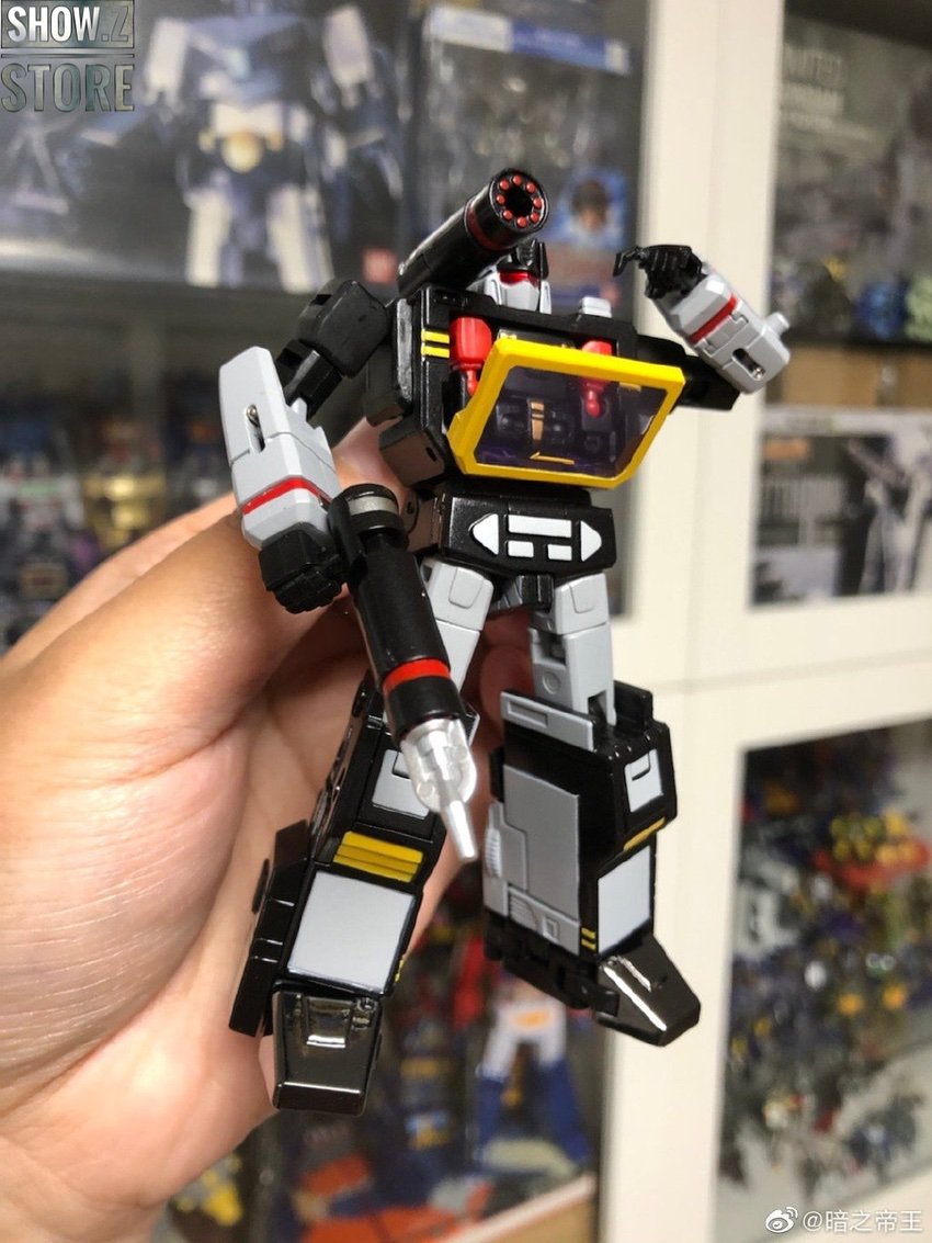 Black and yellow robot in warrior stance with cassette weapon Black and yellow robot in warrior stance with cassette weapon
