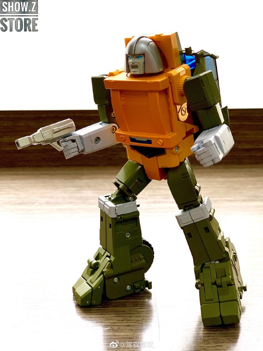Orange green robot facing forward with weapons extended Orange green robot facing forward with weapons extended