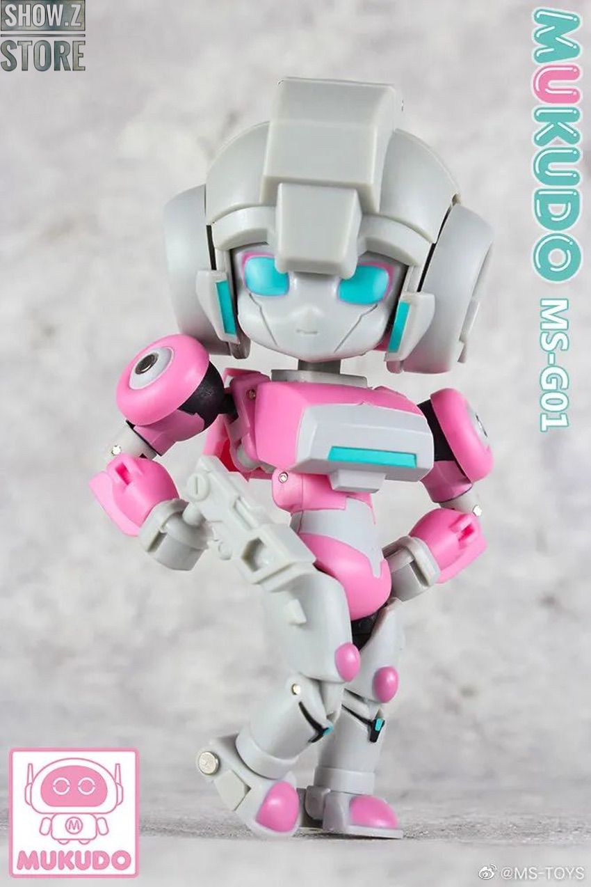 Chibi mecha figure in pink white color scheme posed standing Chibi mecha figure in pink white color scheme posed standing