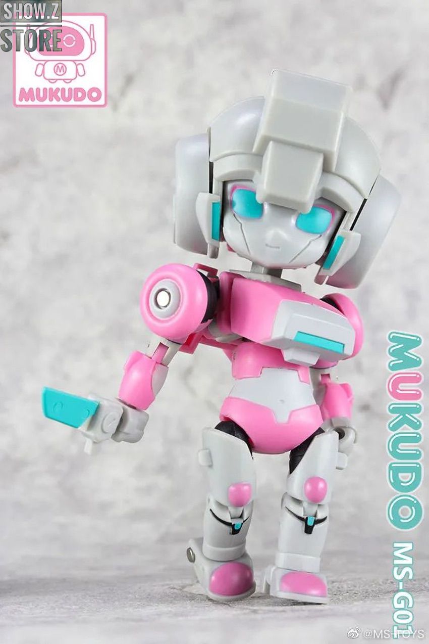 Peach girl Arcee robot shown from side with articulated arms Peach girl Arcee robot shown from side with articulated arms