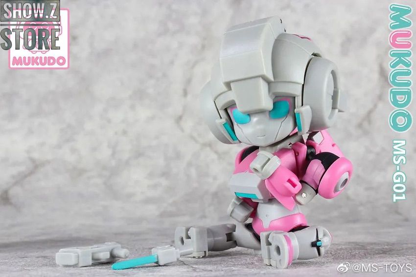 Sitting pose of tiny pink robot with extended limbs Sitting pose of tiny pink robot with extended limbs