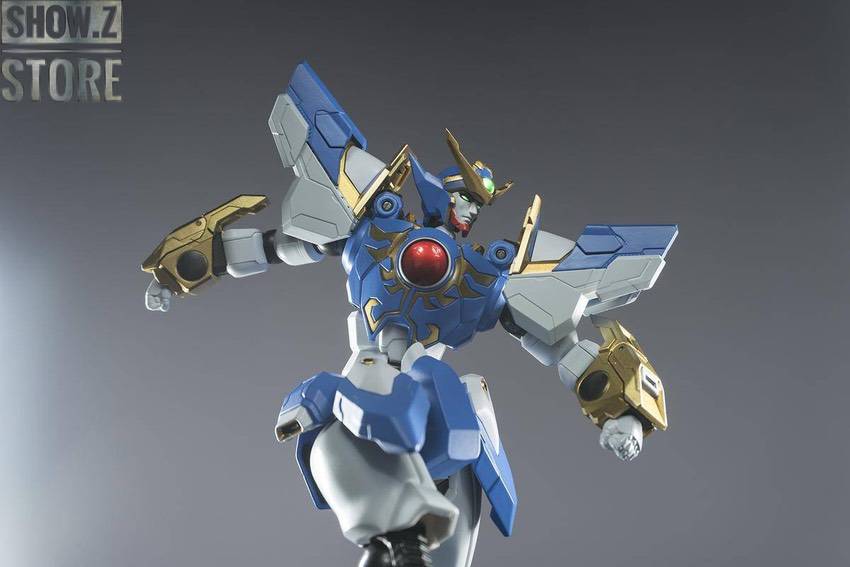 Tall blue white robot figure with golden accessories in action stance Tall blue white robot figure with golden accessories in action stance