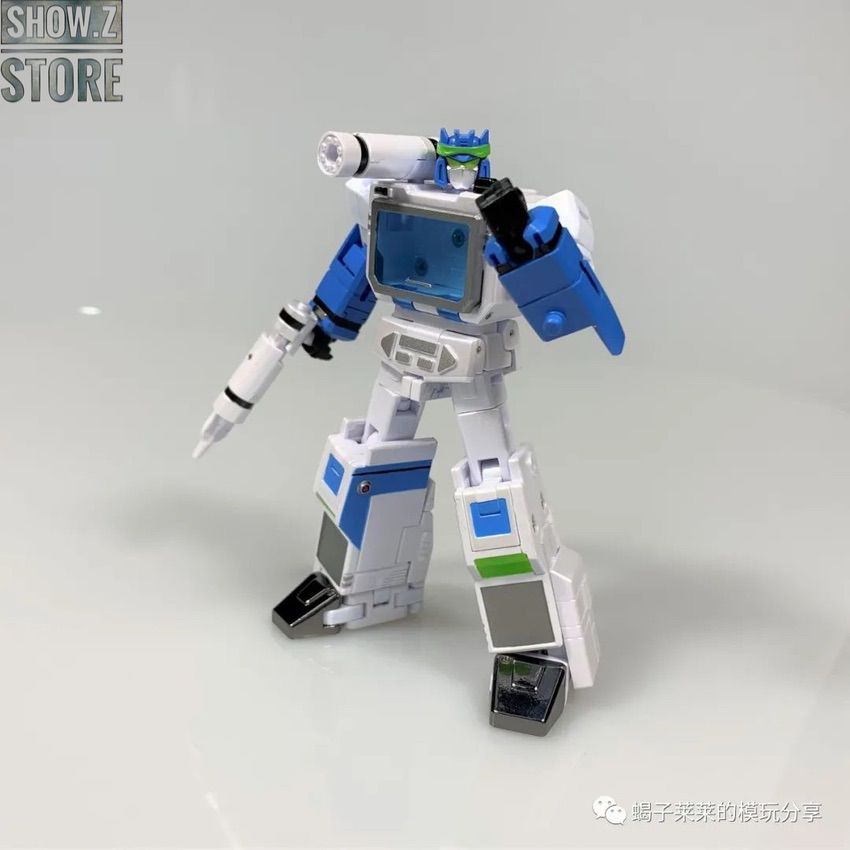 White robot in warrior pose with blue armor and cassette accessories White robot in warrior pose with blue armor and cassette accessories