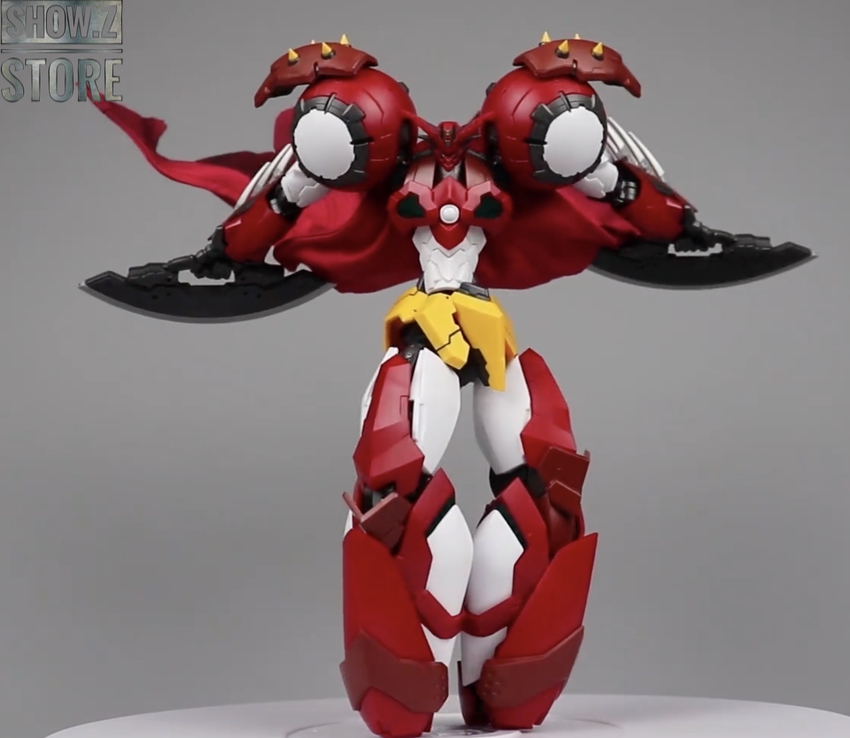 Red mechanical robot figure with spiked wings and yellow optics Red mechanical robot figure with spiked wings and yellow optics
