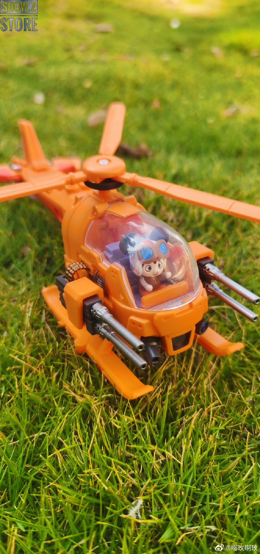 Orange helicopter robot vertical stance walkway display Orange helicopter robot vertical stance walkway display