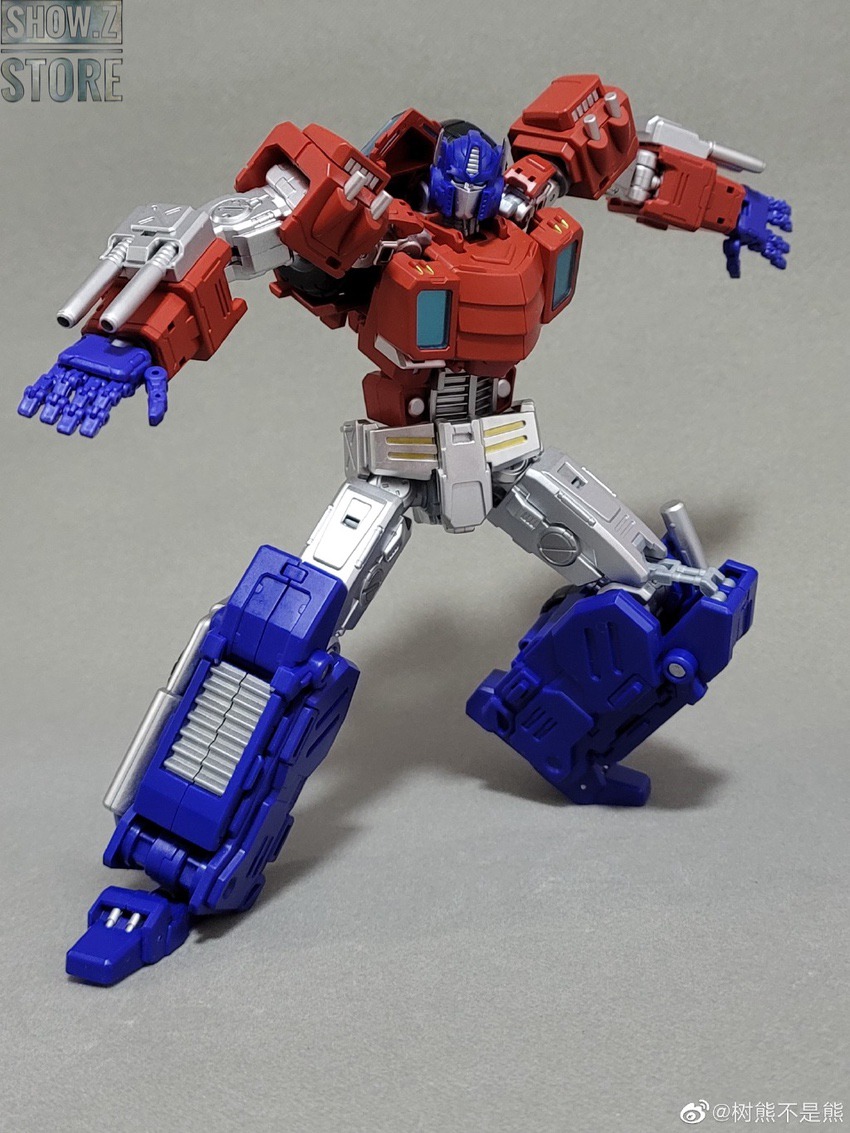 Red robot with blue cannon and silver legs in hero pose stance Red robot with blue cannon and silver legs in hero pose stance