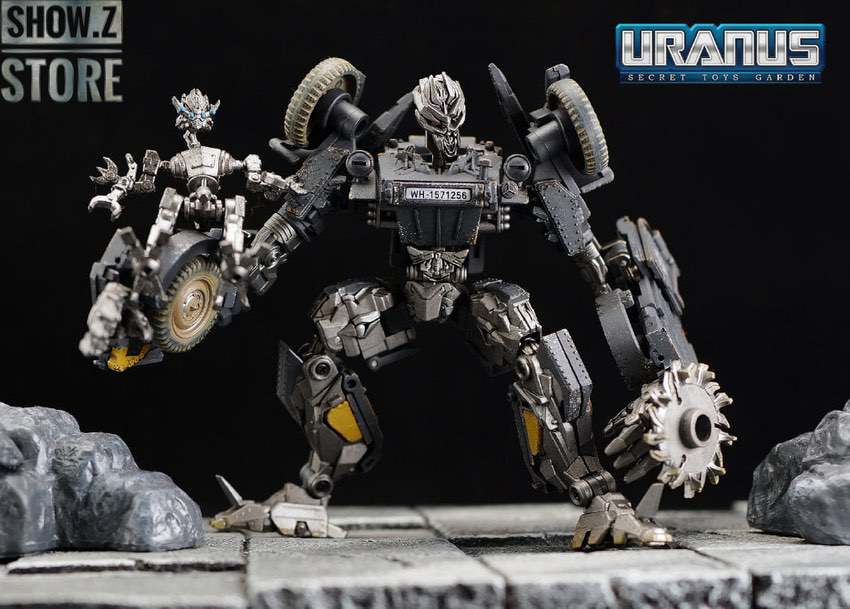 Gray mechanical robot with large wheels and weapon attachments Gray mechanical robot with large wheels and weapon attachments