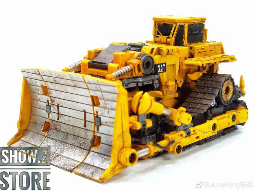 Yellow CAT bulldozer-themed transformer model with detailed treads and cab Yellow CAT bulldozer-themed transformer model with detailed treads and cab