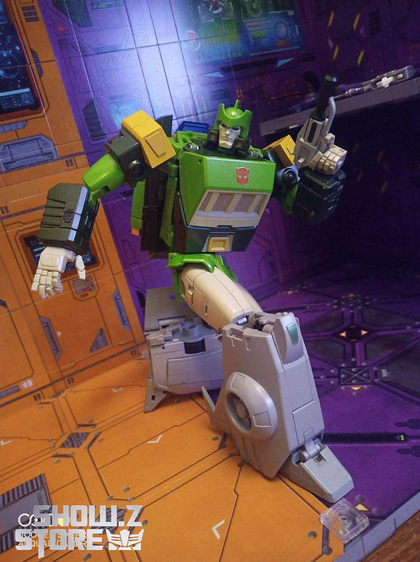 Green and yellow robot figure in transformation robot mode pose Green and yellow robot figure in transformation robot mode pose