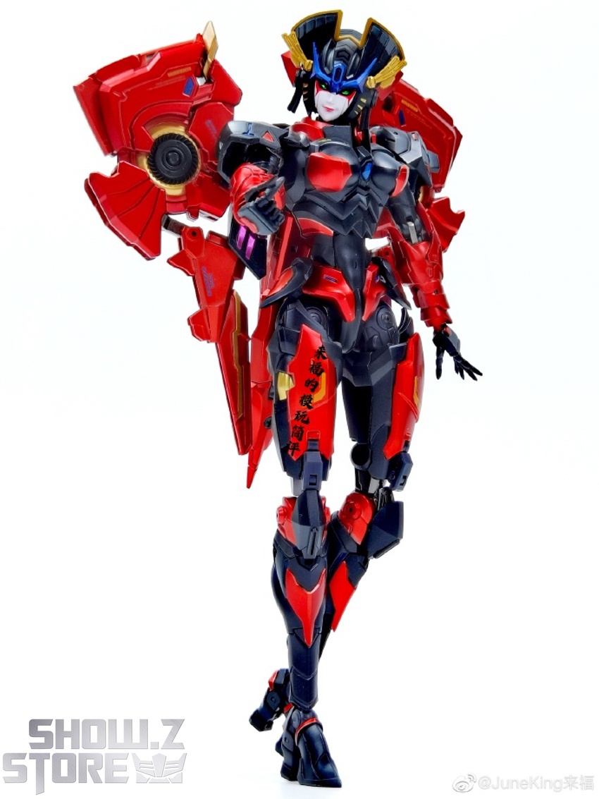Standing robot figure in red armor with blue accents and weapons Standing robot figure in red armor with blue accents and weapons