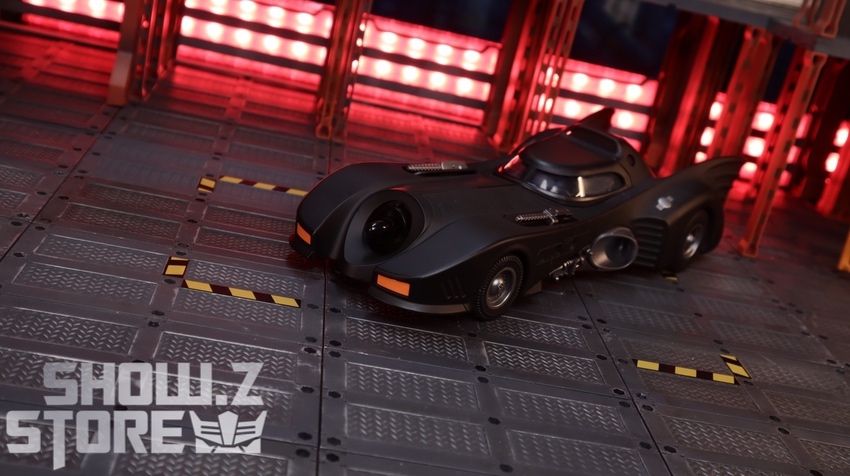 Batmobile front-facing stance glowing red backdrop display Batmobile front-facing stance glowing red backdrop display