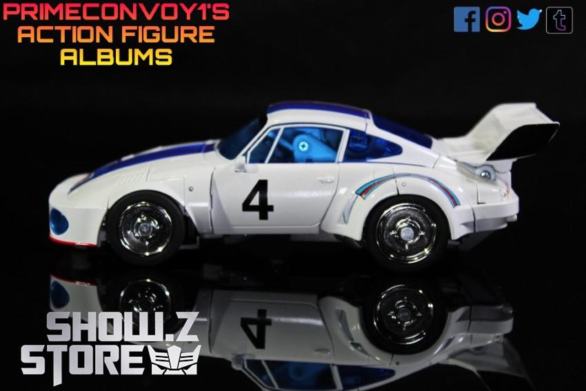 White race car in side profile showing doors open and robot exposed White race car in side profile showing doors open and robot exposed
