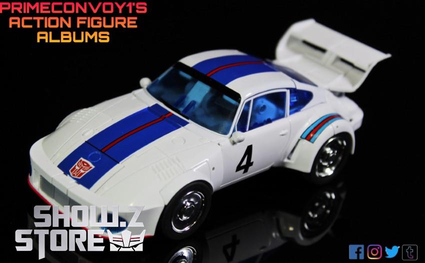 White race car with blue stripe showing aerodynamic spoiler design White race car with blue stripe showing aerodynamic spoiler design