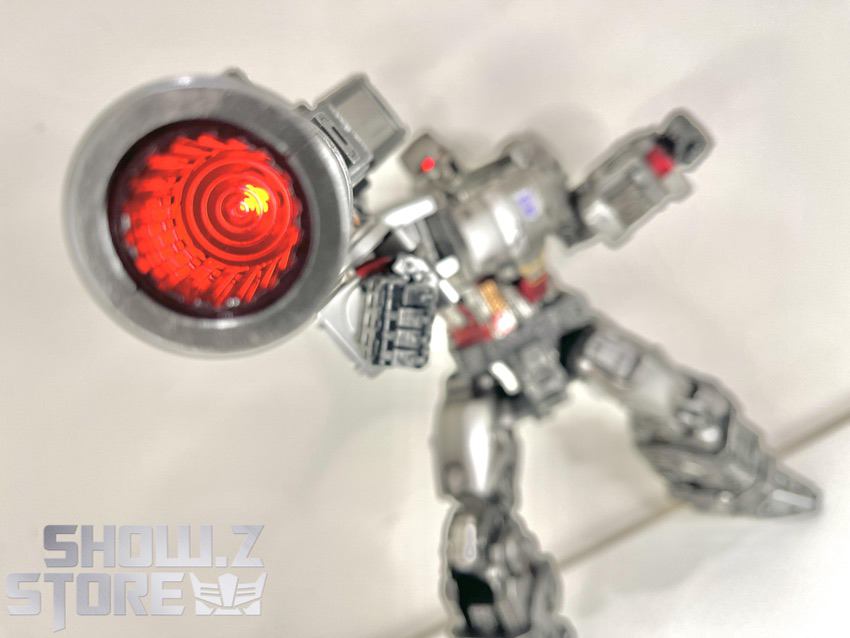MT01 Megatron holding glowing red cannon weapon closeup MT01 Megatron holding glowing red cannon weapon closeup