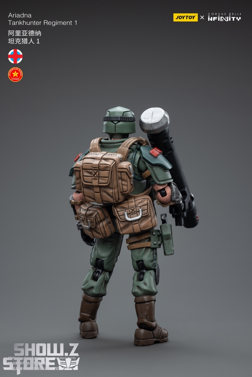 Soldier in green gear carrying large tactical weapon system Soldier in green gear carrying large tactical weapon system