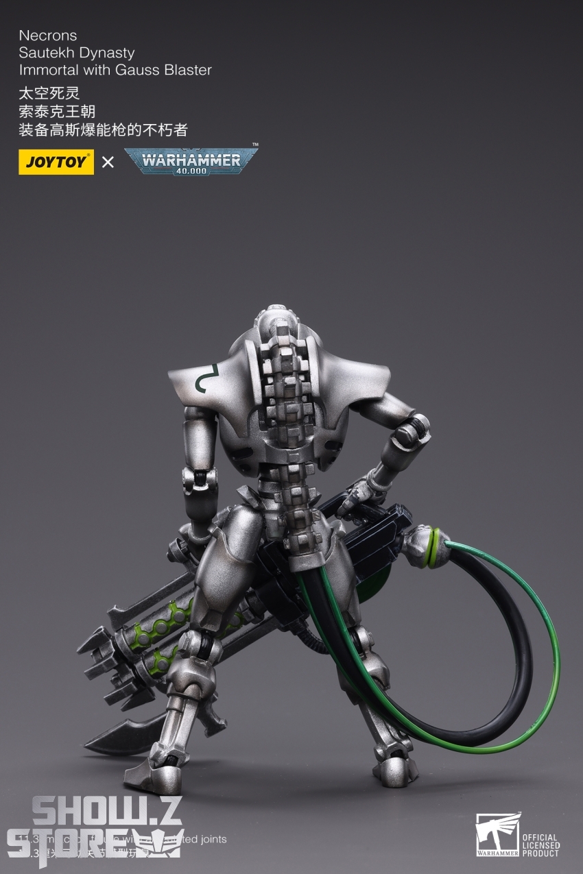 Side view of armored alien warrior with glowing green energy weapon Side view of armored alien warrior with glowing green energy weapon