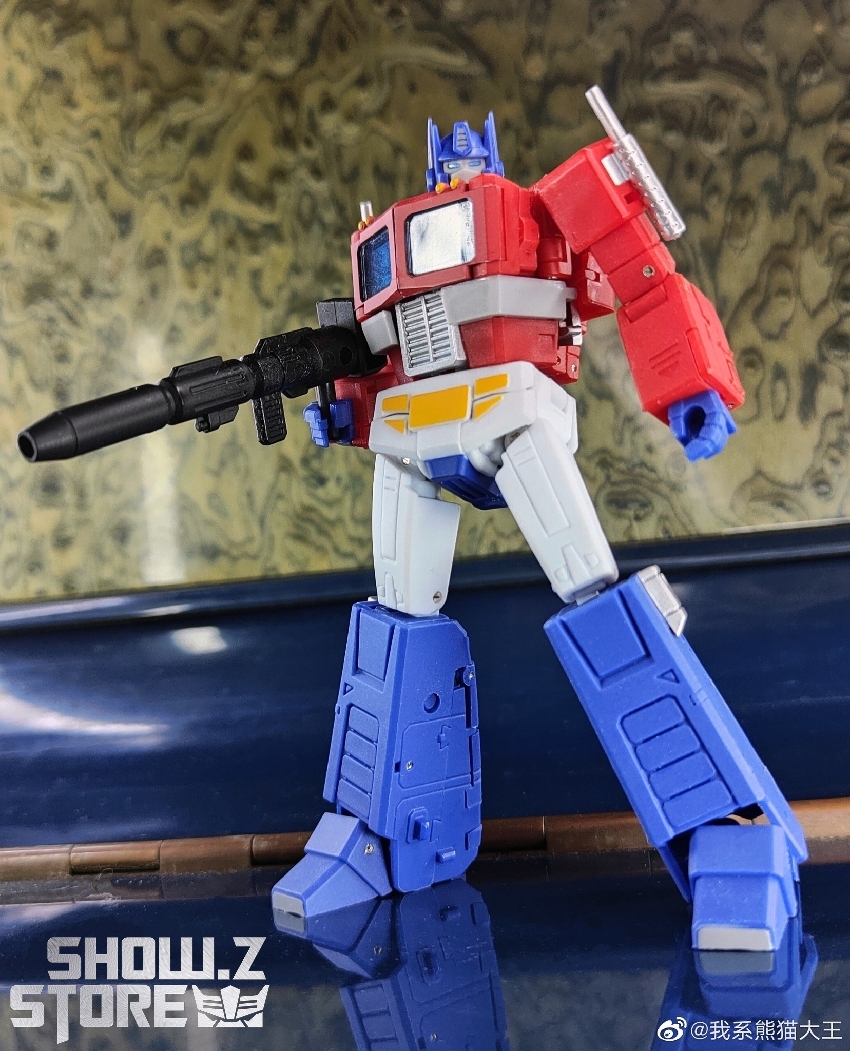 Cyan blue and white Transformers figure with futuristic weapon and armor details Cyan blue and white Transformers figure with futuristic weapon and armor details