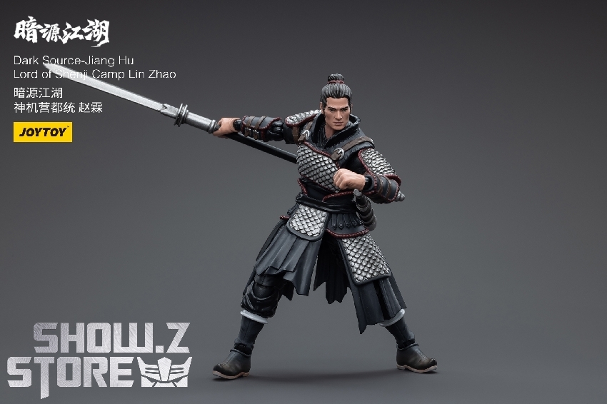 Adult male warrior in scale mail armor holding large ceremonial sword with poise Adult male warrior in scale mail armor holding large ceremonial sword with poise