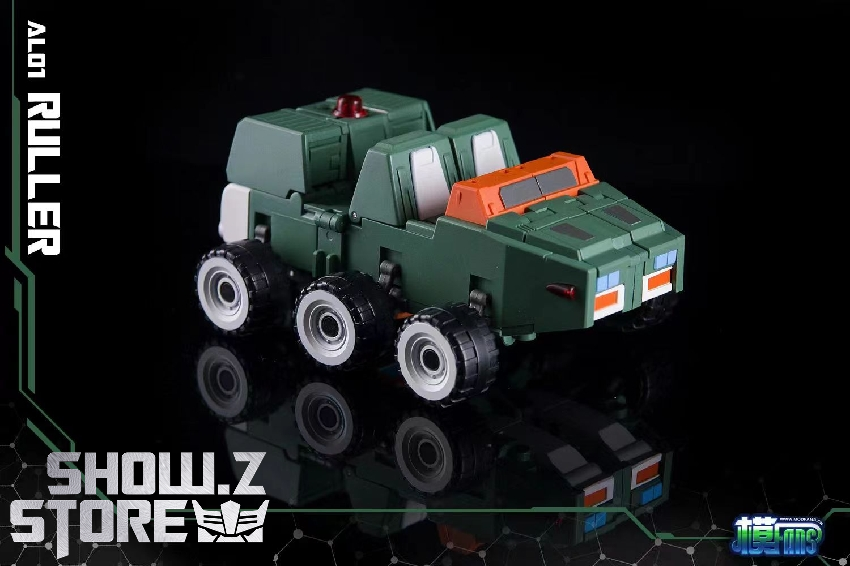 Green military truck undergoing transformation with orange cab and tactical gear displayed Green military truck undergoing transformation with orange cab and tactical gear displayed